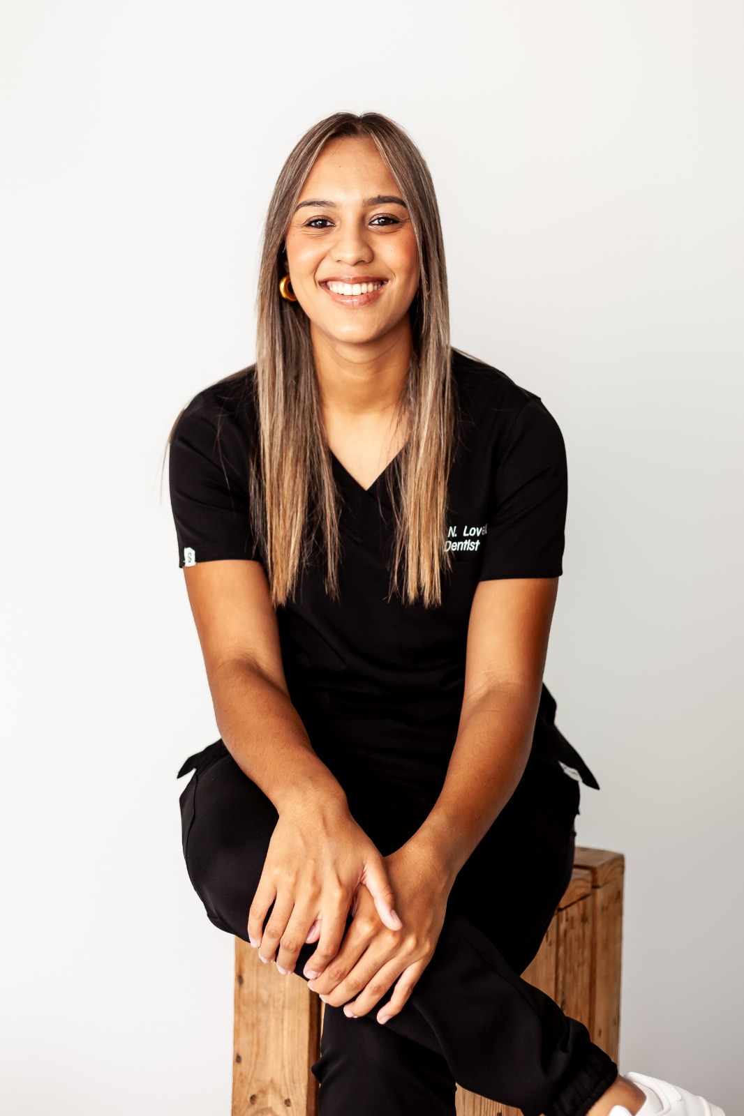 Dr Natalie Lovell smiling, seated portrait